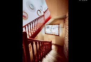 a staircase with red railings in a house at Hostal Albany Ancha in León