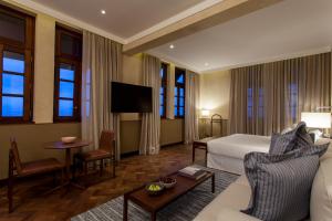 a hotel room with a bed and a tv at Hotel Fasano Salvador in Salvador