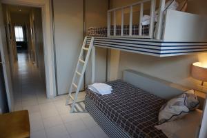 a bedroom with a bunk bed and a ladder at Apartaments Sant Jordi Girona 97 in Barcelona