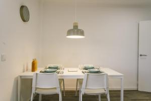 a white table with white chairs and a white wall at Best Houses 73 - Lovely view São Bernardino in Atouguia da Baleia