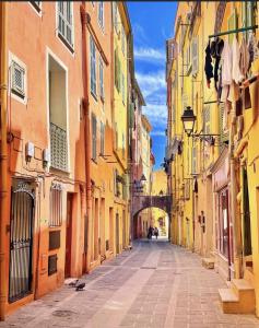 an empty street in a city with buildings at Sablettes Beach-plage-vue mer-centre ville in Menton