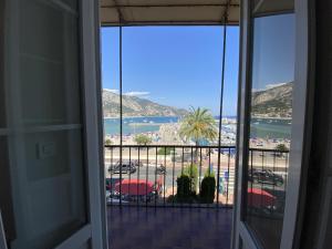 a room with a balcony with a view of a beach at Sablettes Beach-plage-vue mer-centre ville in Menton
