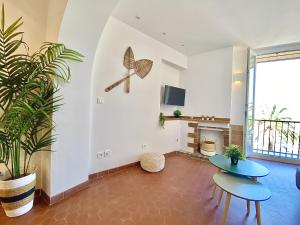 a living room with two tables and a fireplace at Sablettes Beach-plage-vue mer-centre ville in Menton