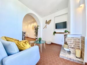 a living room with a blue couch and a fireplace at Sablettes Beach-plage-vue mer-centre ville in Menton