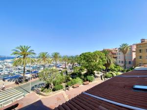 a view of a city with palm trees and a harbor at Sablettes Beach-plage-vue mer-centre ville in Menton