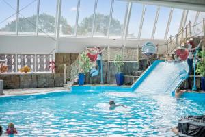 a group of children playing in a swimming pool at First Camp Bøsøre Strand Feriepark in Hesselager