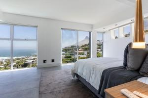 a bedroom with a bed and views of the ocean at The View CampsBay in Cape Town +32 photos