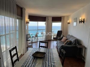 a living room with a couch and a table at FANALS 7 F in Platja  d'Aro