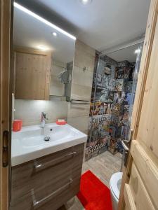 a bathroom with a sink and a toilet and a shower at La chapelle de Monet - logis Eglantine in Bois-Jérôme-Saint-Ouen