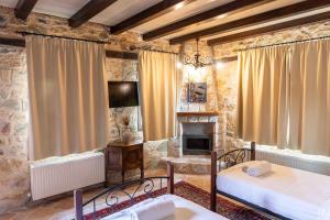 a bedroom with two beds and a fireplace at Lithea mountain resort and spa in Florina