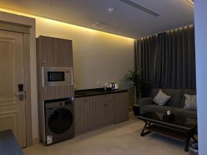 a living room with a kitchen and a washing machine at Land walk Hotel in Riyadh