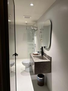 a bathroom with a sink and a toilet and a mirror at Land walk Hotel in Riyadh