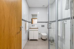 a bathroom with a toilet and a sink and a shower at Asgard Oporto Downtown Apartments in Porto +67 photos