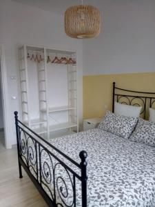 a bedroom with a black bed and a window at Le Saline Bed & Breakfast in Cervia