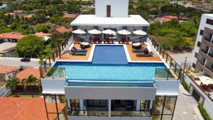 an aerial view of a house with a swimming pool at FLATS ENSEADA Do SOL in Jacumã