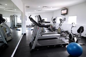 a gym with several tread machines and a blue ball at Ejecutivo Express Consulado in Guadalajara +93 photos