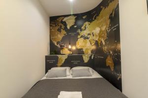 a bedroom with a map of the world on the wall at Atelier Kersauson in Brest