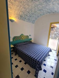 een slaapkamer met een bed in een kamer met een plafond bij Dammuso Sul mare MDQ Sea in Pantelleria