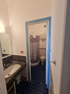 a bathroom with a sink and a toilet at Dammuso Sul mare MDQ Sea in Pantelleria