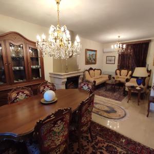 a living room with a dining table and a chandelier at Friendly Flat 5 in Edessa