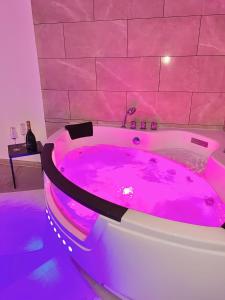 a hot pink bath tub in a pink room at Modern SPA - Cosy & Chic - JACCUZI in Brunoy