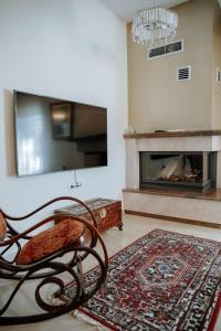 a living room with a chair and a fireplace at Friendly Flat 5 in Edessa