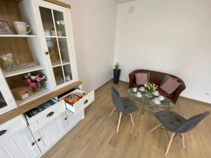 a living room with a table and chairs at Diamentowa 7 Rent Home Konarzewo Poznań in Poznań