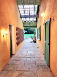 una pasarela entre dos edificios con puertas verdes en Le Chalet, en Charbonnières-les-Bains