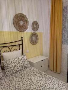 a bedroom with a bed and two plates on the wall at Le Saline Bed & Breakfast in Cervia