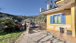 a house with a gate and a car parked next to it at Ca' del Bosco in Alassio