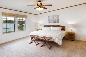 a bedroom with a bed and a ceiling fan at Lake House Lakeside Escape 1 Bass Fishing Spot Chickamauga in Decatur