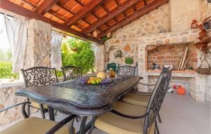 a dining room with a wooden table and chairs at Amazing Home In Lozovac With Kitchen in Lozovac