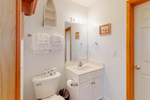 a white bathroom with a toilet and a sink at South Shore Haven in Rodanthe +29 photos