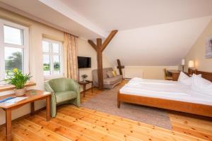 a bedroom with a large bed and a living room at Elbterrasse Wörlitz in Oranienbaum-Wörlitz