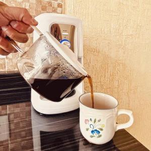 a person is pouring coffee into a cup at casa buu in San Miguel de Allende