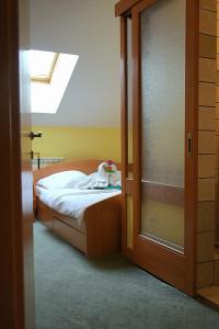 a bedroom with a bed and a window at Hotel Lupus in Novi Sad