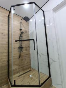 a walk in shower with a glass enclosure at Квартира Алия in Aktobe +19 photos