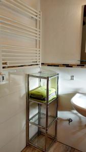 a glass stool in a bathroom with a sink at Ferienhaus auf dem Werteshof in Peißenberg