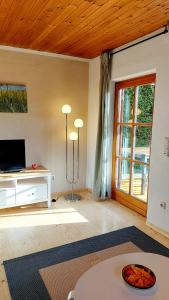 a living room with a table and a window at Ferienhaus auf dem Werteshof in Peißenberg