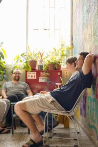 a man laying on a chair in a room at Jungle Jaffa Hostel Age 18 to 45 in Tel Aviv