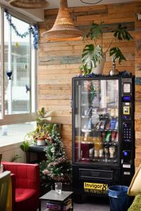 a living room with a christmas tree in front of a refrigerator at Jungle Jaffa Hostel Age 18 to 45 in Tel Aviv