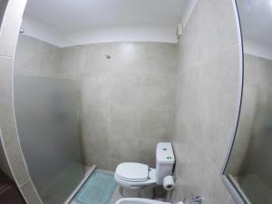 a small bathroom with a toilet and a shower at Alojamiento en Ushuaia - Mirador del Beagle in Ushuaia +8 photos