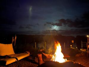 a fire pit with a couch next to it at night at Cour De Berlin in Fürstenberg