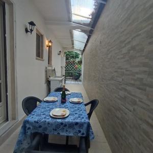 a table with a blue and white table cloth on it at Appartamento Via Dei Glicini in Laigueglia