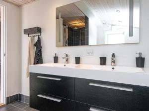 a bathroom with a sink and a mirror at 4 person holiday home in Børkop-By Traum in Egeskov