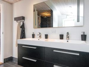 a bathroom with a sink and a mirror at Two-Bedroom Holiday home in Børkop 9 in Egeskov