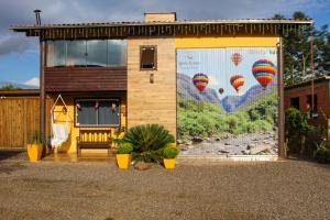 a building with a mural of hot air balloons at Pousada Rancho Alvorada in Praia Grande
