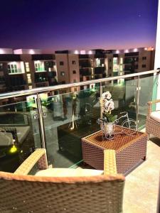 a balcony with a table with a vase of flowers on it at Magnificent Pent House w/Jacuzzi in Santiago de los Caballeros