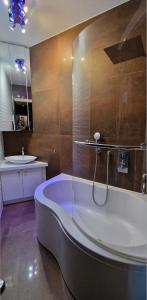 La grande salle de bains est pourvue d'une baignoire et d'un lavabo. dans l'établissement Cocosmann, à Paris