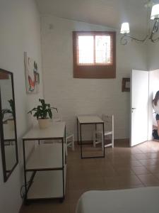 a living room with two tables and a window at Amarello in Gualeguaychú